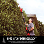 Photo of Craftsman pole hedge trimmer CMCPHT818B trimming tall bushes outdoors, extended for maximum reach.