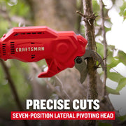 Photo of Craftsman CMCPPR320B electric pruner cutting a tree branch outdoors, red body, visible blade.