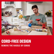 Photo of a person using a Craftsman cordless hot glue gun CMGL100B for a craft project at a kitchen table.