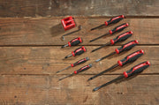 A set of nine CRAFTSMAN screwdrivers, an Allen wrench, and a red holder, displayed on a wooden surface. The screwdrivers