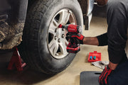Photo of CRAFTSMAN cordless impact wrench CMMT98282 being used on a car wheel, mechanic gloves visible.