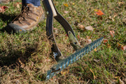 Photo of Craftsman lawn rake CMXMLTP35317 in use on grass, metal blade visible with close-up angle.