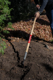 Photo of Craftsman garden tool CMXMLTP35319 with wood handle used to dig soil outdoors.