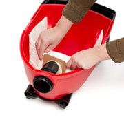 Photo of hands installing a vacuum bag inside a red CRAFTSMAN wet/dry vacuum, SKU CMXZVBE43270, interior top view.
